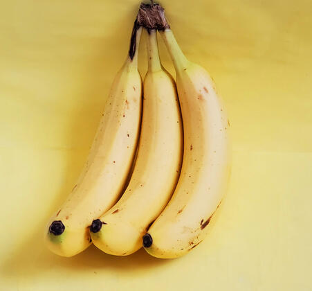 Bunch of bananas with yellow background